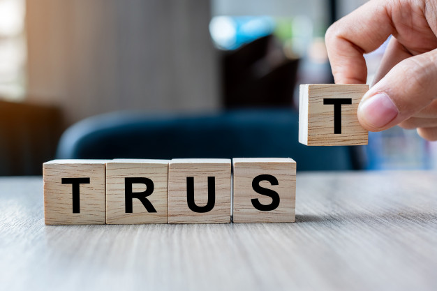 Businessman Hand Holding Wooden Cube Block With Trust Business Word Table Background 42256 1453